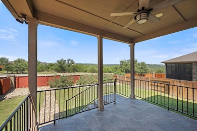 Balcony with a ceiling fan and a patio area