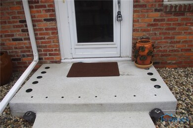 Newly poured front porch concrete with custom glas