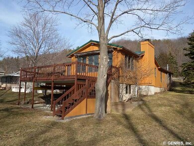 Exterior Front. The gently sloping lawn surrounds 