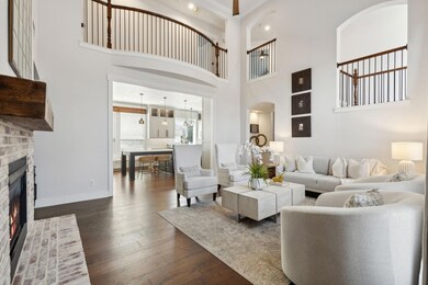 Living area with dark wood-type flooring, baseboar