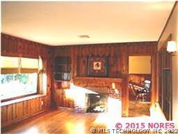 Living room with window seat, built-ins and decora