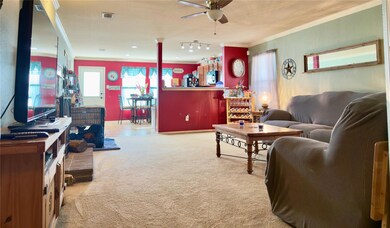 Carpeted living room featuring crown molding and c