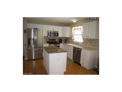 Wonderful kitchen has island with granite countert