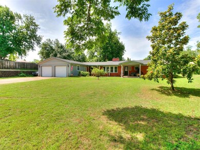 Ranch-style home with a garage and a front yard