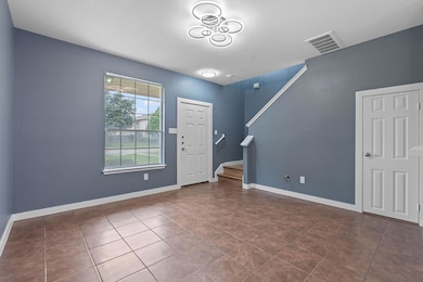 Entrance foyer featuring stairs, tile patterned f