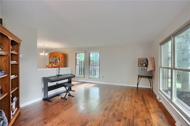 The open living room features hardwood flooring, b