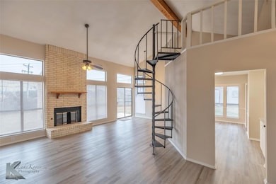 Unfurnished living room featuring light hardwood /