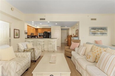 Living room featuring sink, crown molding, and lig