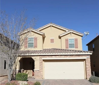 View of front of house with a tiled roof, driveway