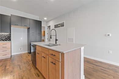 Kitchen featuring light wood-style flooring, stai