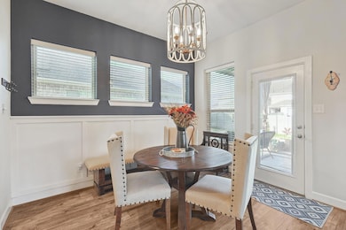 Dining area featuring wainscoting, light wood-styl
