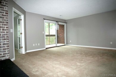 Carpeted Living Room with doors to screened-in bal