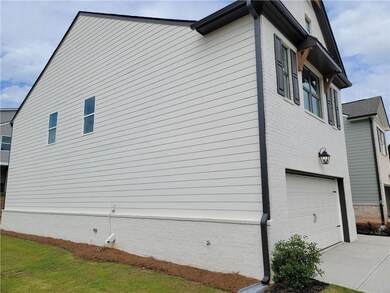 View of property exterior with driveway, a garage, and brick siding