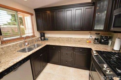 Another view of kitchen with window looking out to