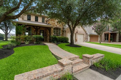 Long, paved walkway leads to a warm and inviting f