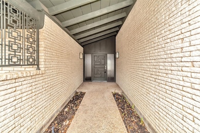 Doorway to property featuring brick siding