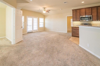 Kitchen with stainless steel microwave, light col
