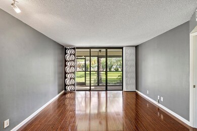 Livingroom overlooks trees and Lush landscaping
