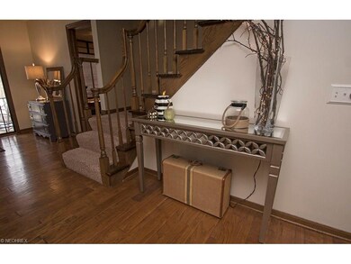The open staircase has plush carpet and a rich, wa