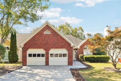 Single story home featuring brick siding, a front yard, concrete driveway, roof with shingles, and a garage