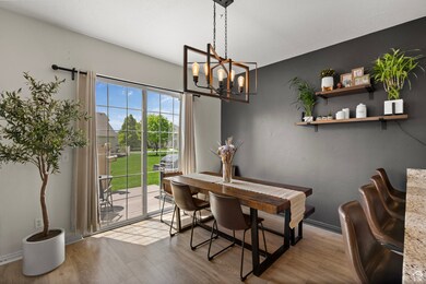 Dining area featuring a chandelier, wood finished floors, and baseboards