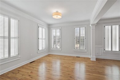 Beautiful crown molding, ornate columns, and light