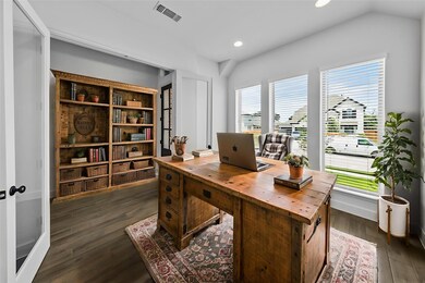 Home office with dark wood-style flooring, recess