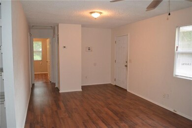 entryway, living room and hallway leading to bathr