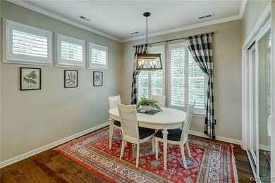Wood floored dining space featuring ornamental mol