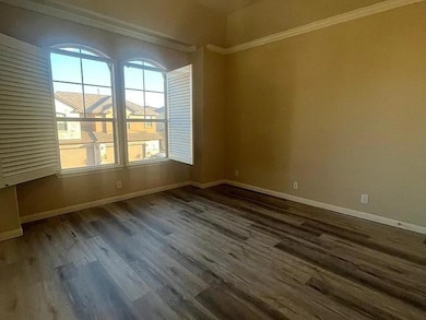 Empty room with baseboards, ornamental molding, a