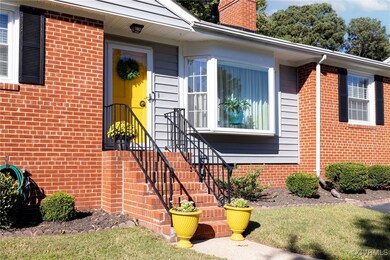 View of front entry w/ brick steps & sturdy stair