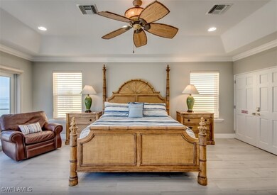 Bedroom with ceiling fan, light hardwood / wood-st