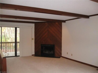 Living room/dining room with fireplace and entrance to porch