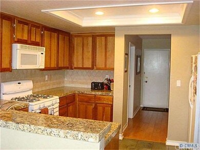 Kitchen with bathroom behind in hall and door lead