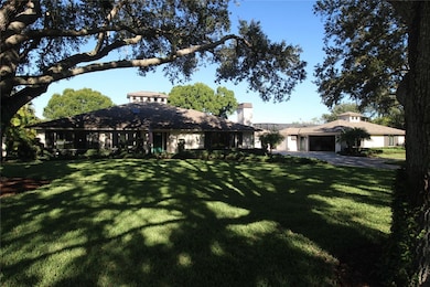 View of front facade featuring a front yard and a chimney