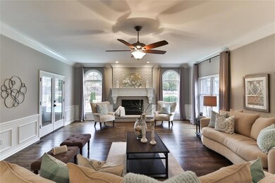 Massive family room with fireplace, views of the pool area and direct access to the screened in porch