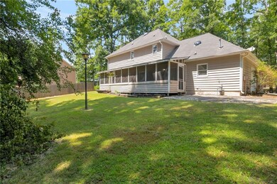 Rear view of property with a sunroom and a patio area