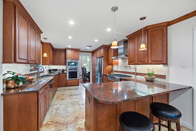 Spacious kitchen has stainless appliances and stai