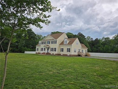 Rear view of house featuring a lawn, fence, and cr