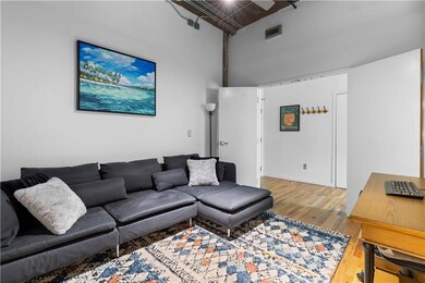 Living room with a high ceiling and wood finished floors
