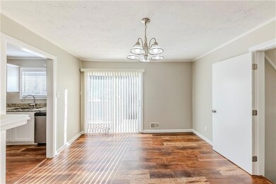 Spare room featuring a textured ceiling, dark hard