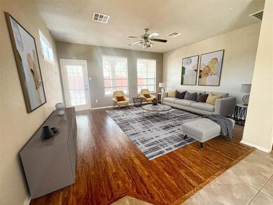 Living area featuring baseboards, a ceiling fan, 