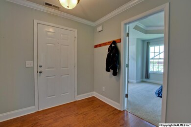 with wood floors and crown molding.