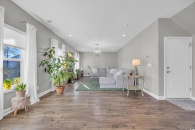 Unfurnished living room featuring dark hardwood / 