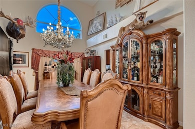 Dining space with visible vents, a towering ceilin