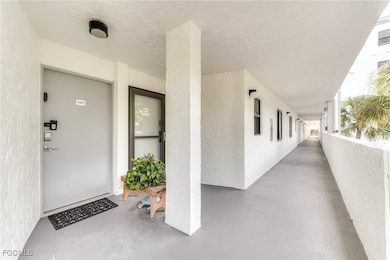 Entrance to property with stucco siding