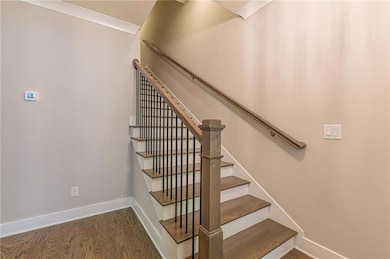 Stairs featuring baseboards and wood finished floo