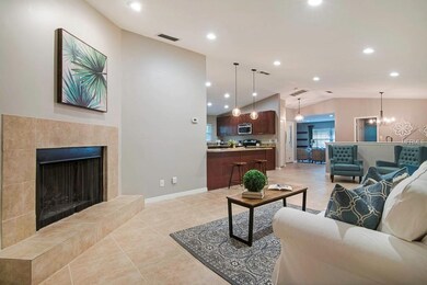View of the living area & fireplace with the kitch