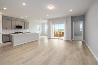 Kitchen featuring gray cabinetry, open floor plan