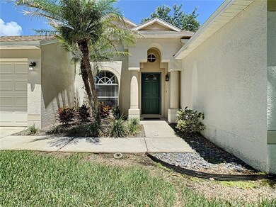 Front entrance featuring robellini palm
